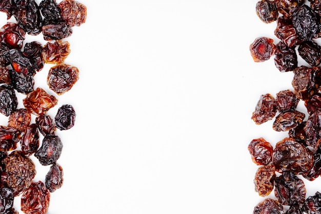 Top view of dried cherries on white background with copy space