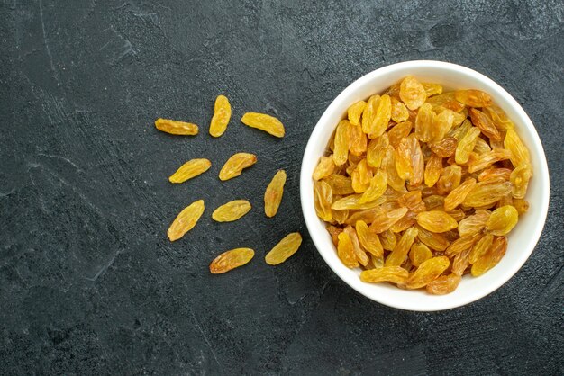 Top view dried grape raisins inside plate on dark surface raisin fruits dried sour