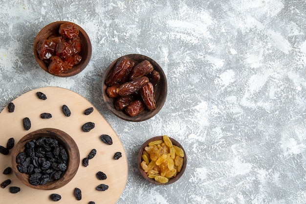 Top view dried khurma with different raisins on white space