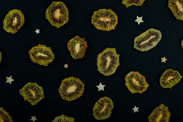 Top view of dried kiwi slices isolated on black background