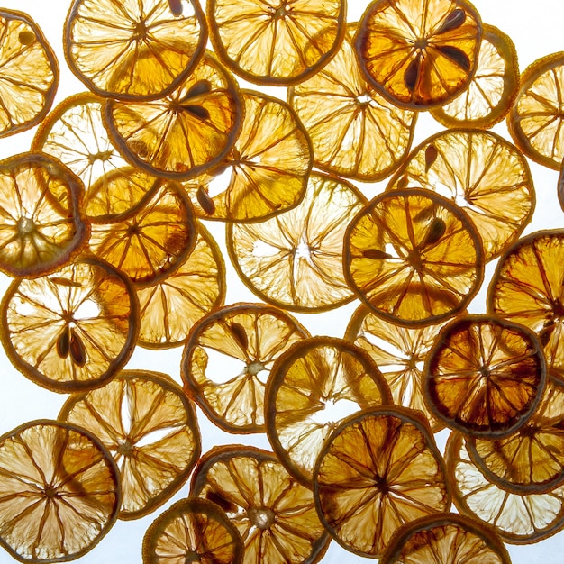 Top view dried lemon pieces pattern on bright white background