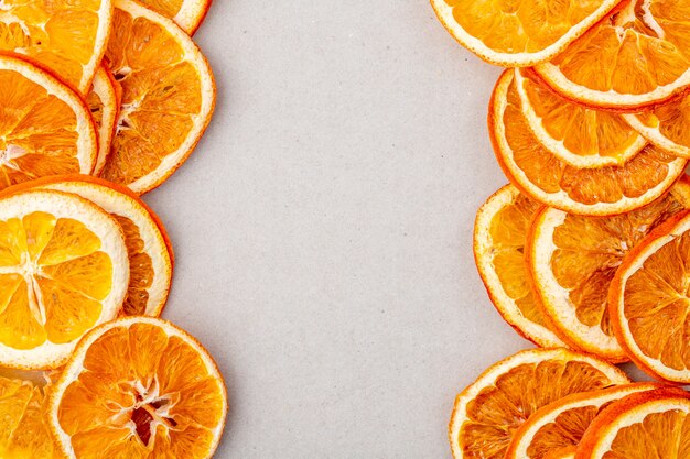 Top view of dried orange slices arranged on white background with copy space