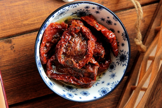 Top view dried plum in a plate on the table