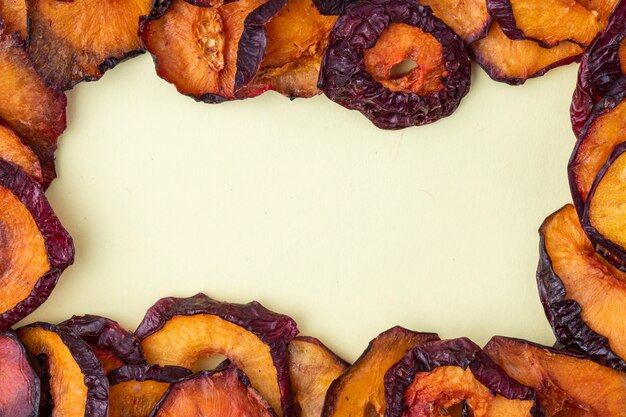 Top view of dried plum slices isolated on a white background with copy space