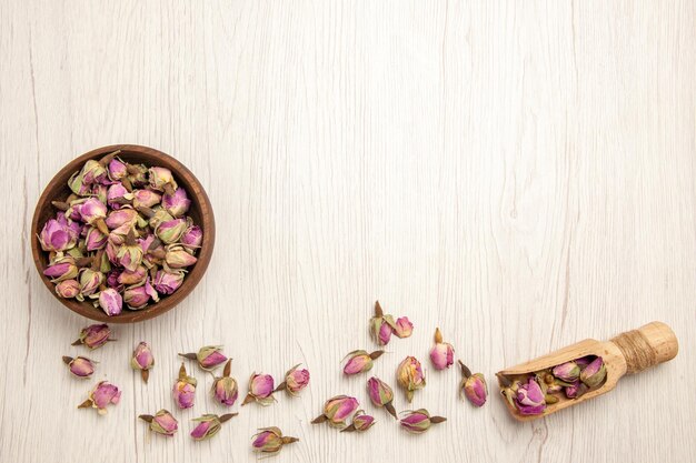 Top view dried purple flowers on white desk color flower purple