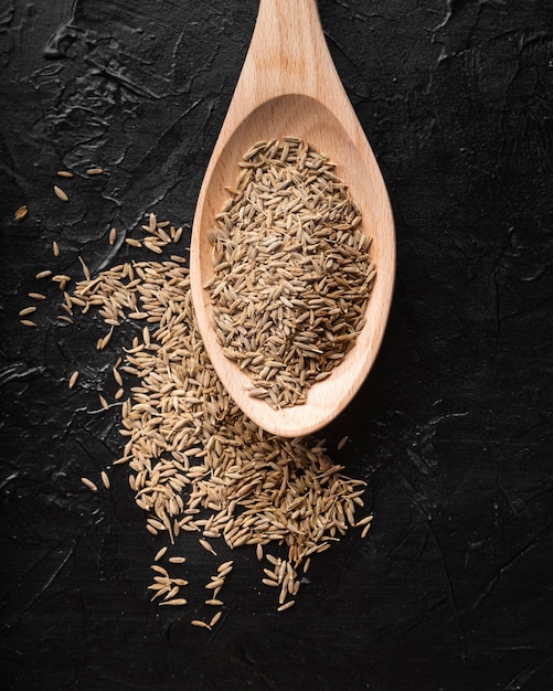 Top view dried rosemary on wooden spoon