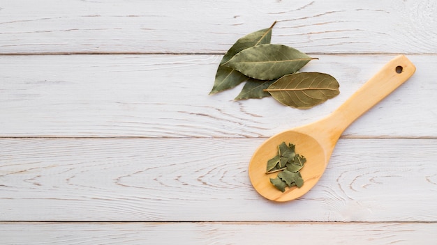 Top view dry leaves on wooden background