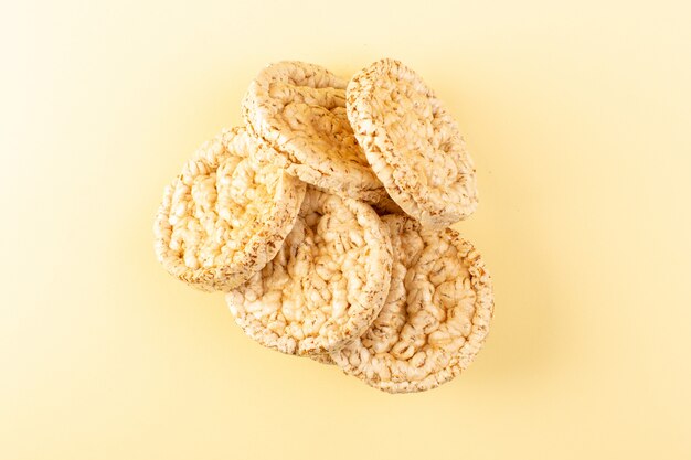 A top view dry salted crackers round cracking isolated on the cream