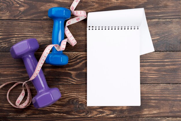 Top view dumbbells with notebook