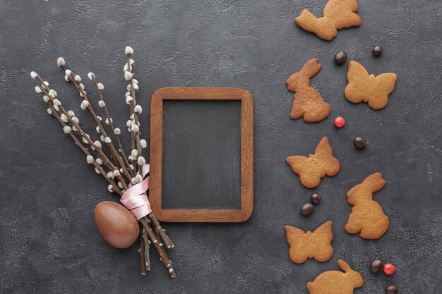 Top view of easter bunny shaped cookies with chocolate egg