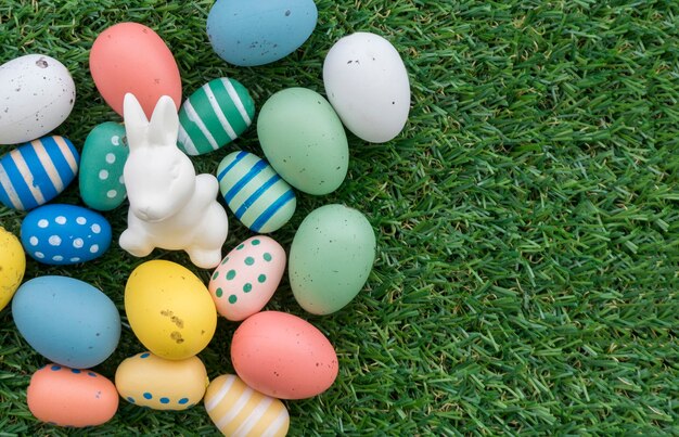 Top view of easter eggs and bunny on grass surface