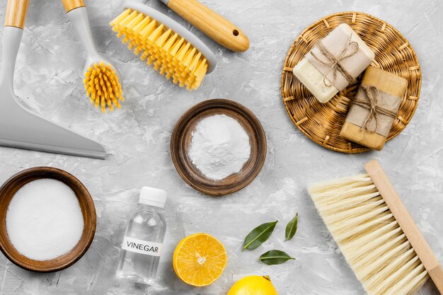 Top view of eco cleaning products with baking soda and brushes