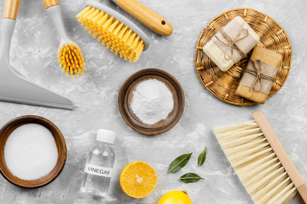 Top view of eco cleaning products with baking soda and brushes