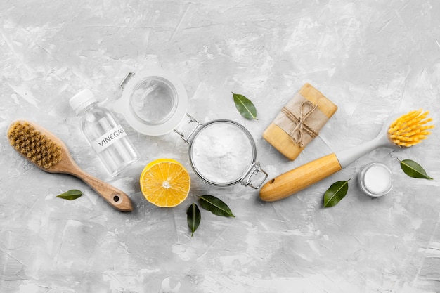 Free photo top view of eco-friendly cleaning products with brushes and lemon