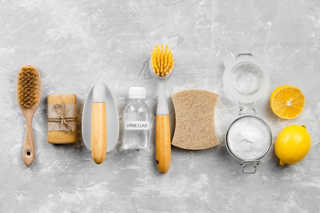 Top view of eco-friendly cleaning products with lemon and brushes