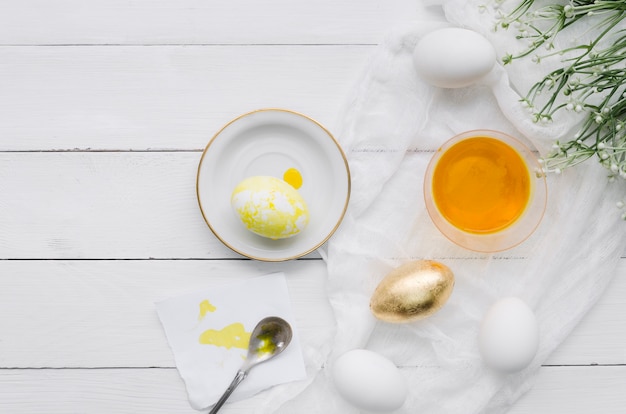 Top view of egg for easter with dye and plant