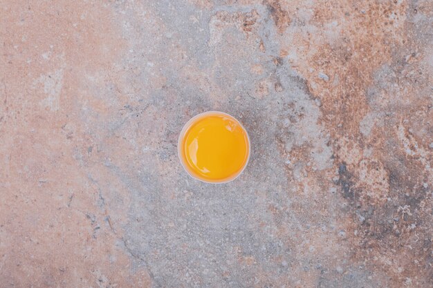 Top view of egg yolk isolated on marble table.