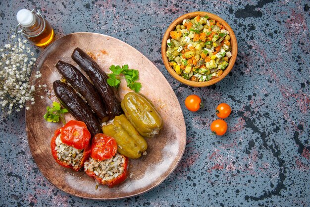 top view eggplant dolma with cooked tomatoes and bell-peppers filled with ground meat inside plate, dish color dinner food meal