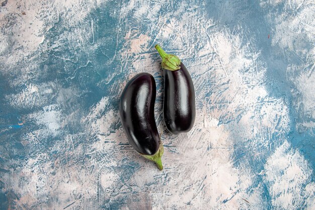 Top view eggplants on blue-white background