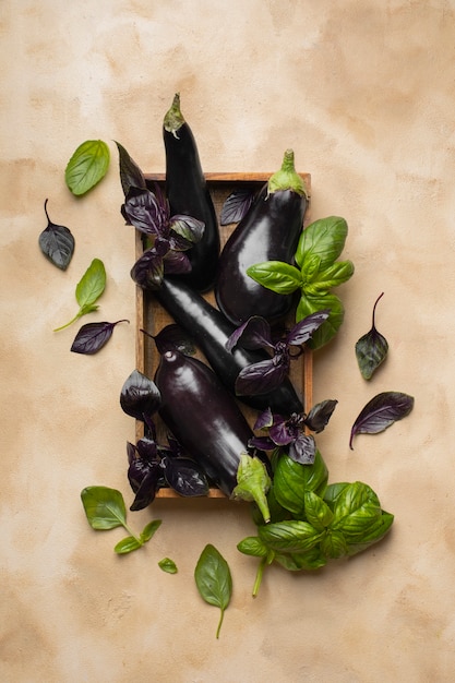 Top view of eggplants with basil leaves