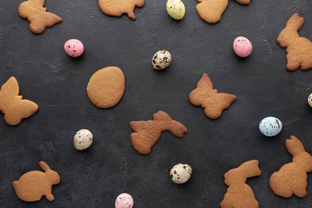 Top view of eggs and bunny shaped cookies for easter