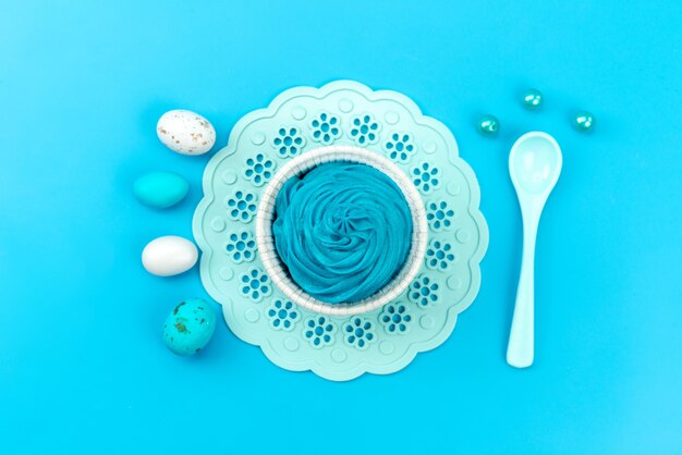 A top view eggs and dessert blue, and white, with white, spoon isolated on blue, color food