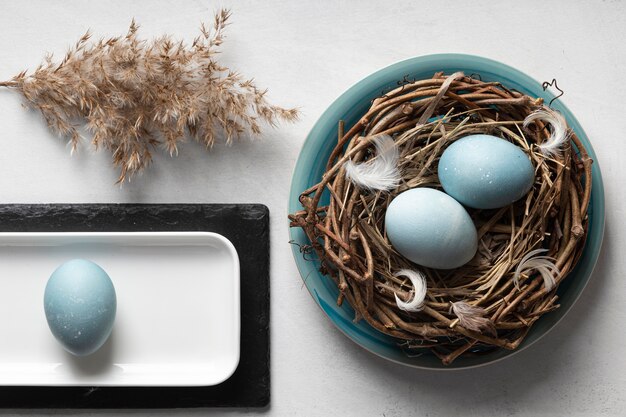 Top view of eggs for easter with bird nest and plate