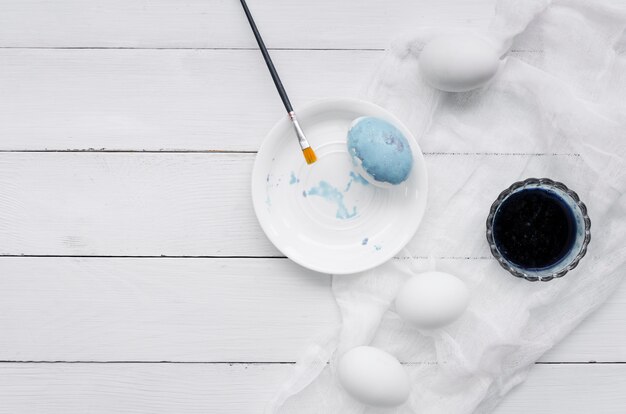 Top view of eggs for easter with dye and textile