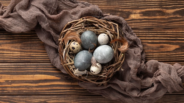 Free photo top view of eggs for easter with fabric and bird nest