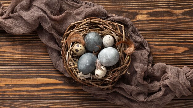 Top view of eggs for easter with fabric and bird nest