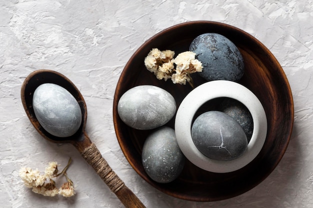 Top view of eggs for easter with wooden spoon and plate