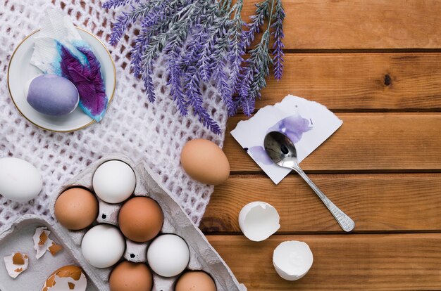 Top view of eggs and paint for easter with lavender