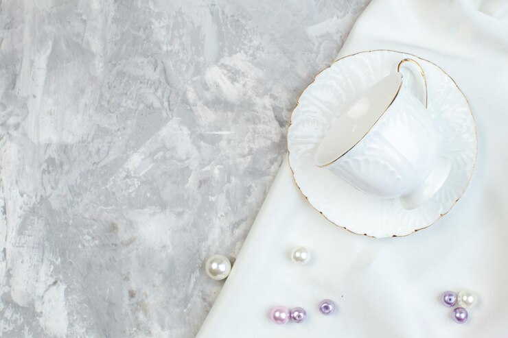 Free Photo top view elegant cups with beautiful beads on white surface horizontal photo feminine picture glass colour