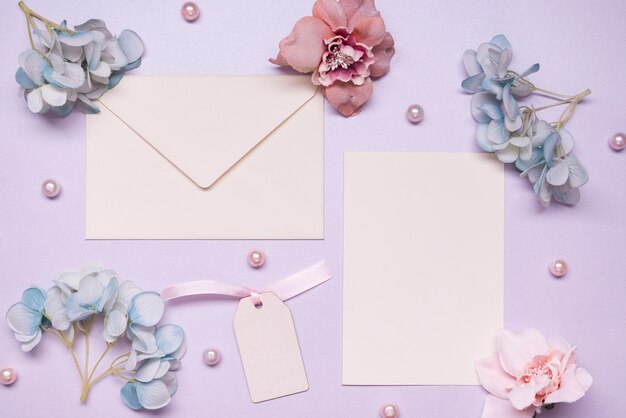 Top view elegant envelope with flowers on the table