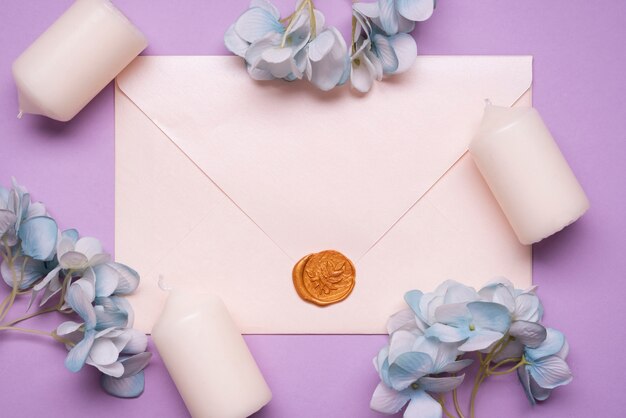 Top view elegant envelope with wedding candles