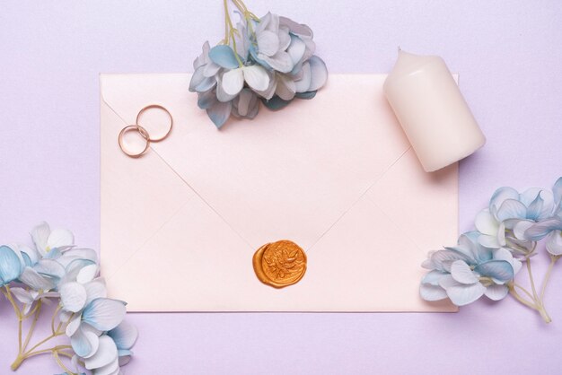 Top view elegant envelope with wedding rings