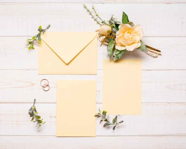 Top view elegant envelopes with wedding flowers