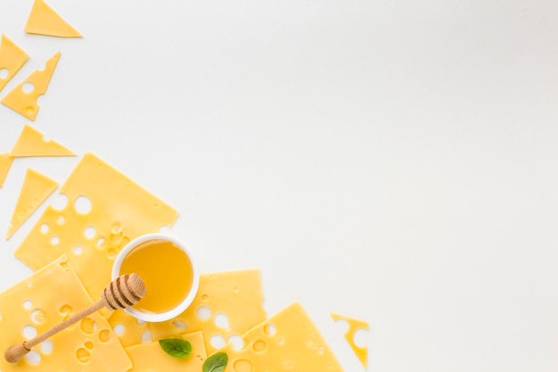 Top view emmental cheese slices and honey with copy space