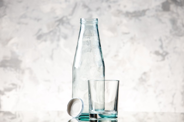 Top view of empty bottle and cap a glass on ice wall with free space