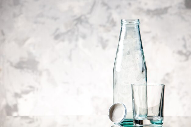 Top view of empty bottle and cap a glass on the left side on ice wall with free space