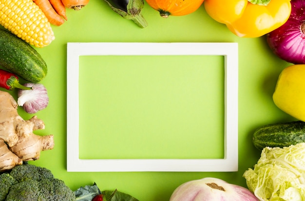 Top view empty frame with arrangement of vegetables