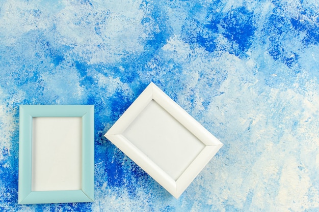 Top view empty frames on blue white grunge with free place