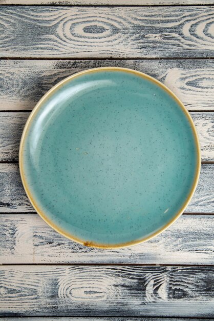 Top view empty glass plate green ed on grey-rustic surface