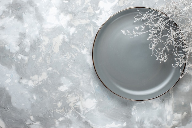 Top view of empty grey plate on white, plate kitchen cutlery desk,