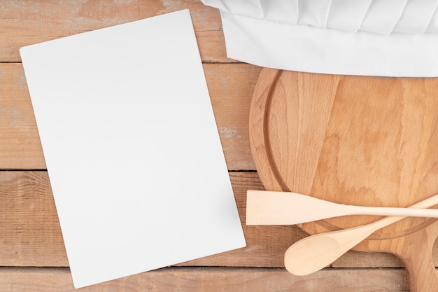 Top view of empty menu paper with wooden spoons