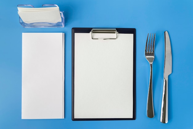 Top view of empty menu with fork and knife