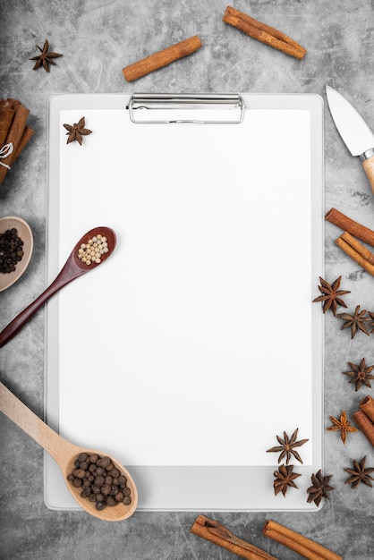 Free photo top view of empty menu with star anise and cinnamon sticks