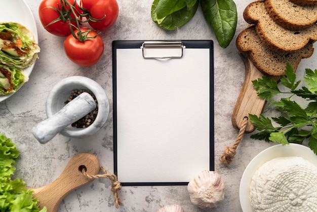 Top view of empty menu with tomatoes and bread