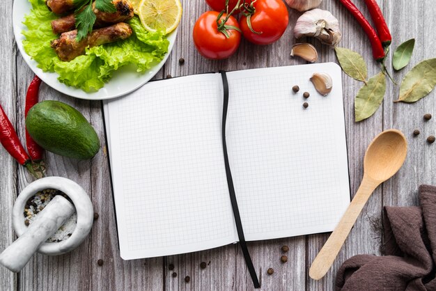 Top view of empty menu with tomatoes and salad