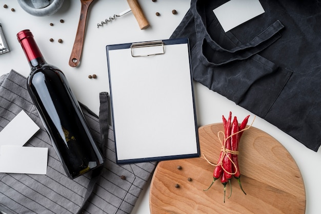 Top view of empty menu with wine bottle and chili peppers